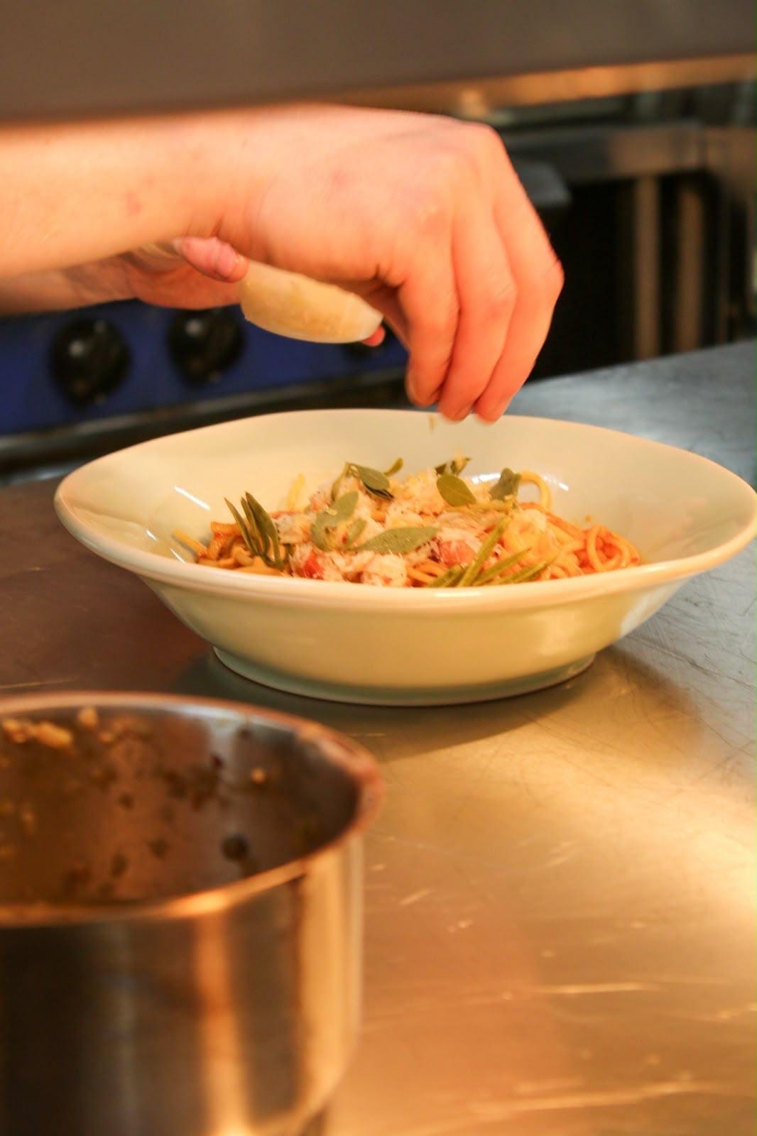 Hands garnishing a dish in the Latimers kitchen