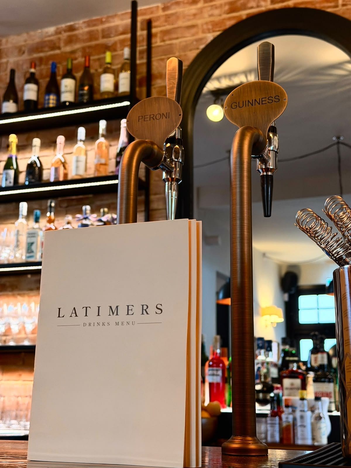The bar at Latimers in Romsey, with the menu standing by the taps